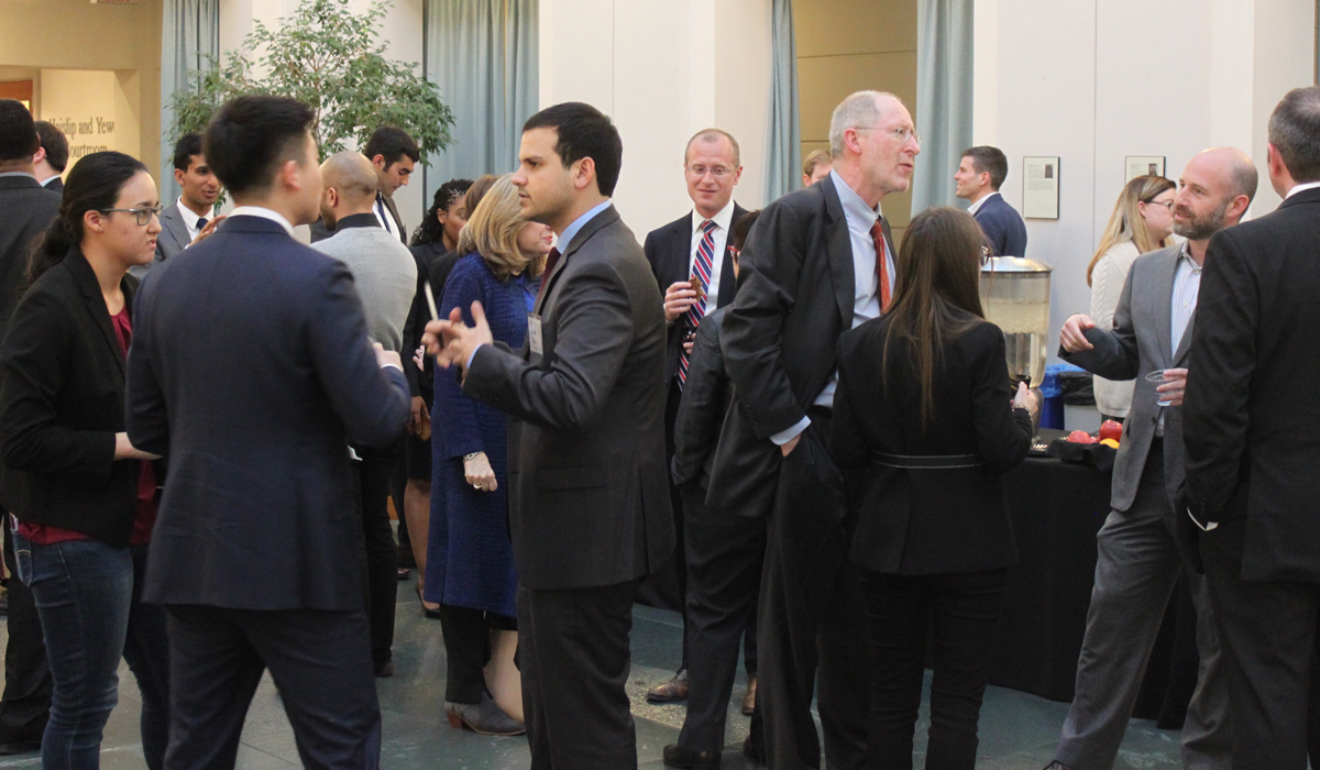 group of people at a reception in the law school atrium