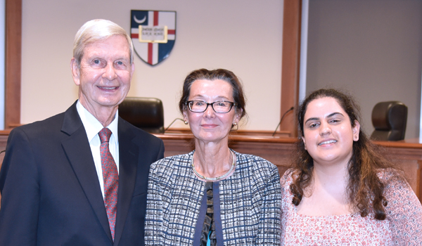 Judge Pietsch poses with her husband and a law student