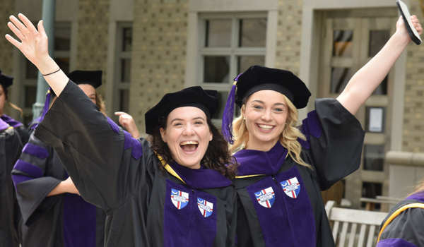 two students celebrating commencement