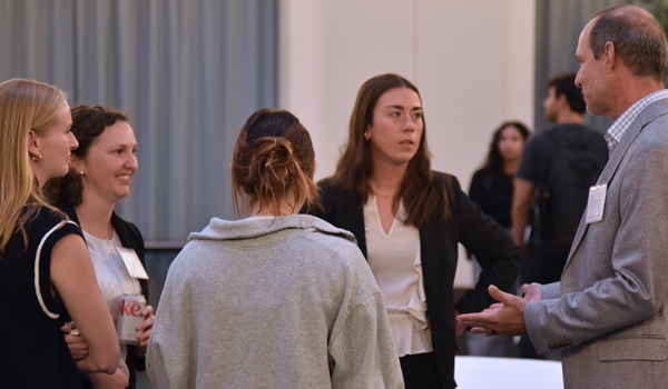 panelists talking to students after event