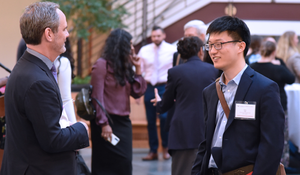 Dean talking to a student at the induction ceremony