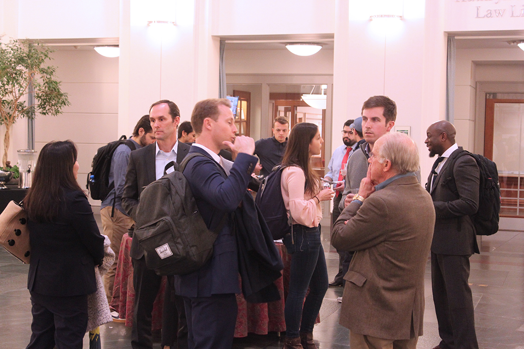 Group of students and alumni networking in the law school atrium