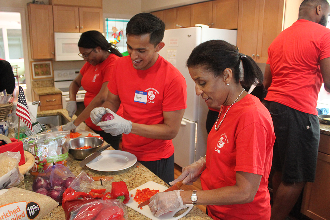 Students and faculty volunteering in kitchen